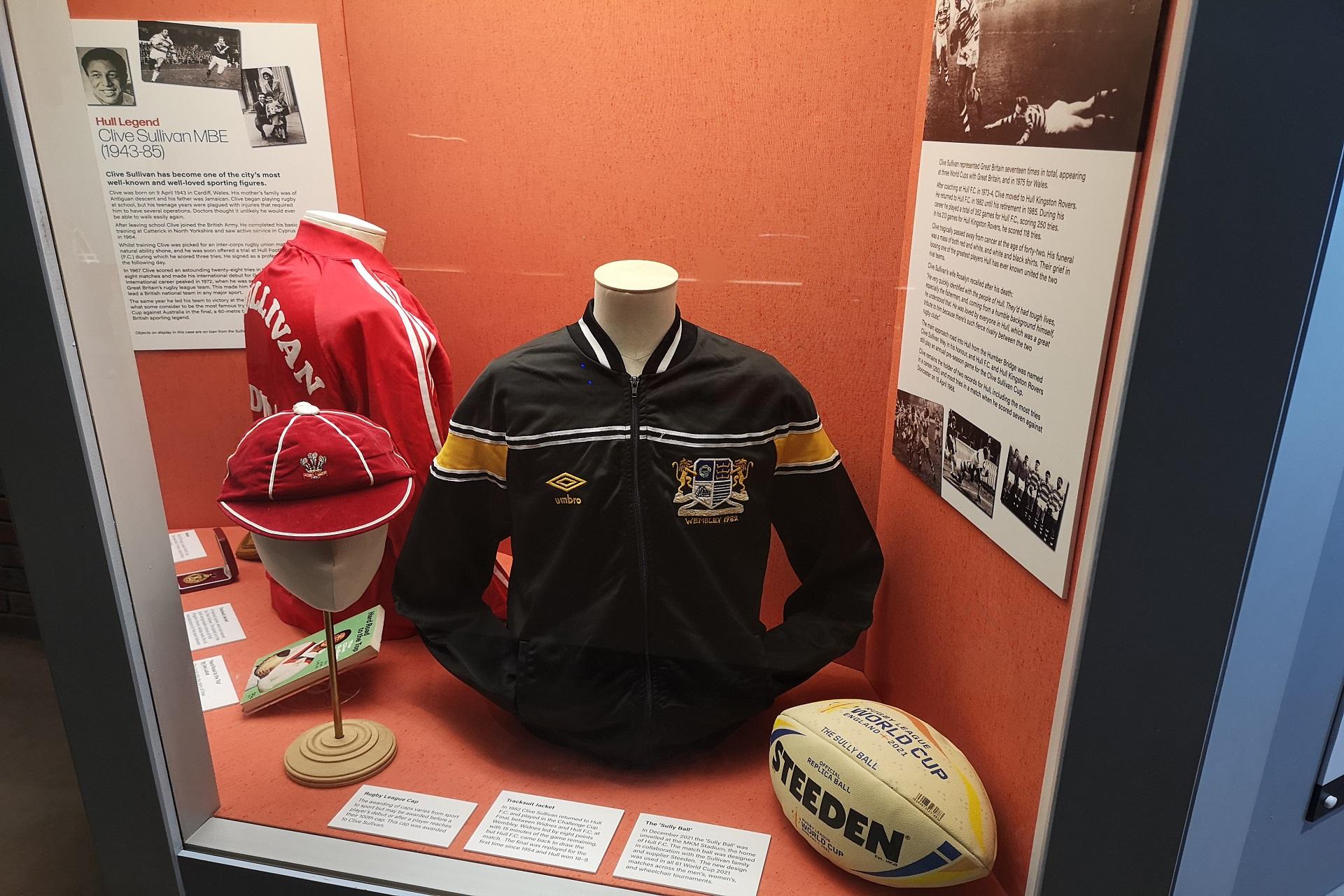 A display of sports clothing including tracksuit tops