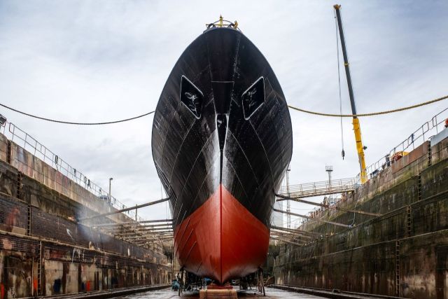 The Arctic Corsair ship in a dry dock with a crane in the background.