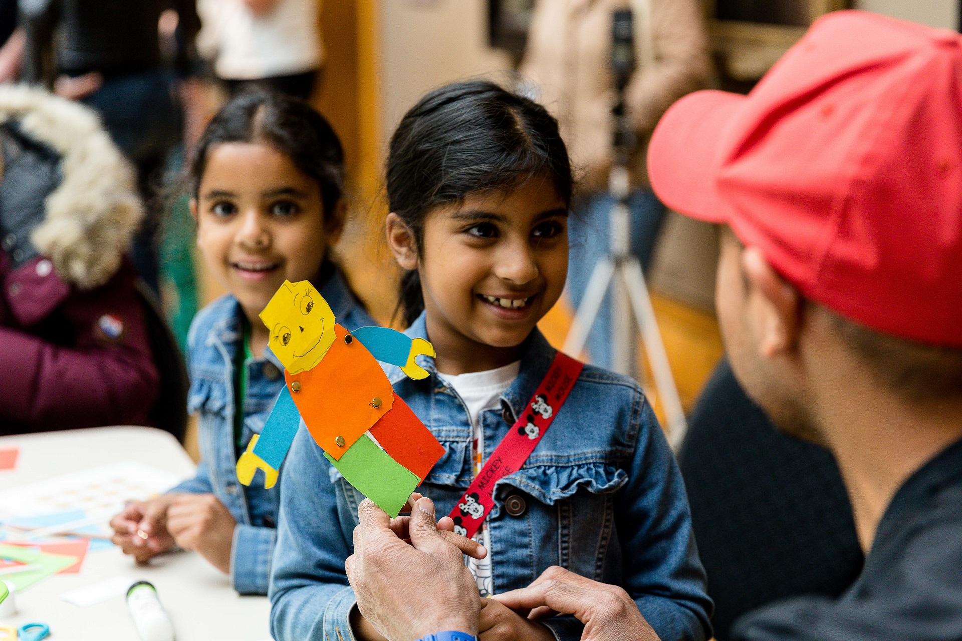 Two girls taking part in a craft activity.