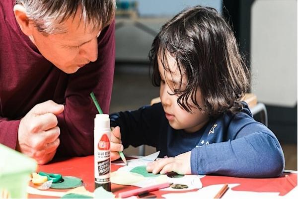 A father and son playing with arts and crafts
