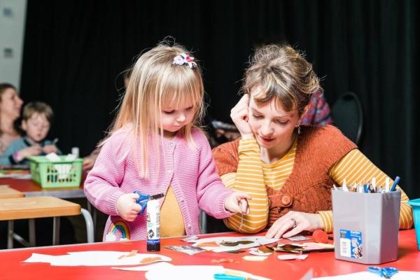 Mother and child are playing with crafts.