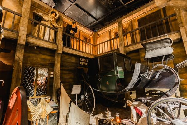 A horse drawn coach display in a museum