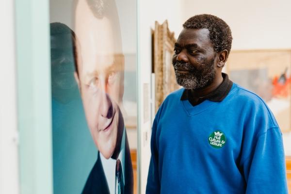 A man looking at a painting