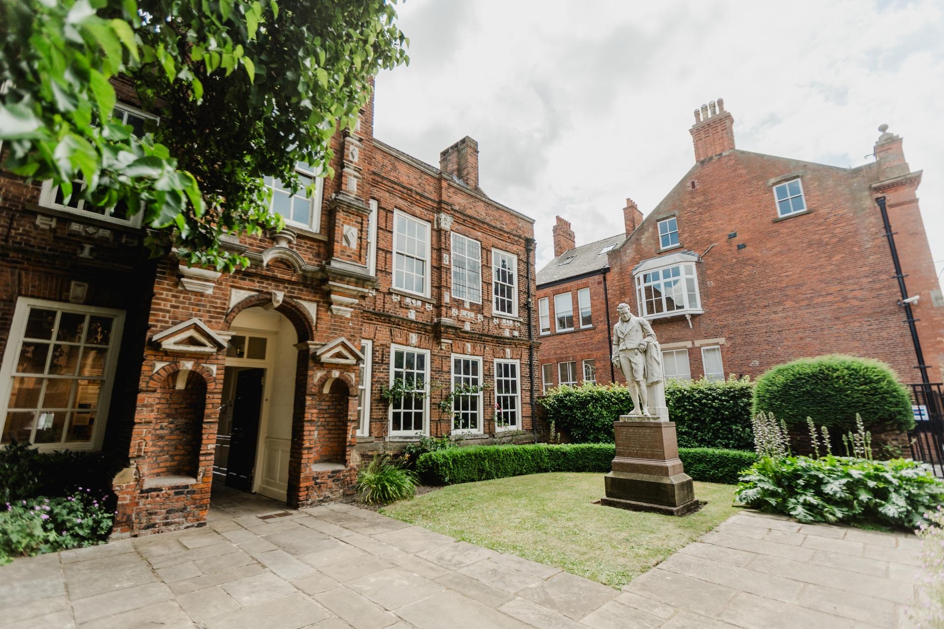 A two storey red brick building with white framed windows