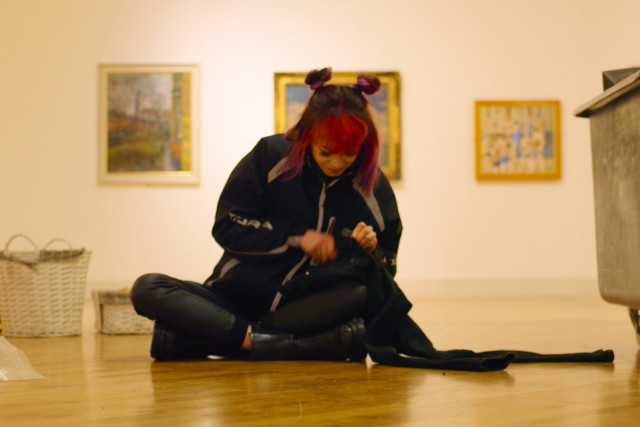 Young women sat on the floor sewing