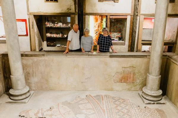 A small group of people looking at Roman exhibition