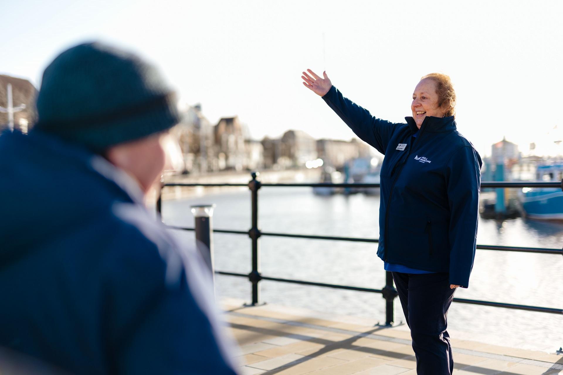A woman with her arm up pointing towards something