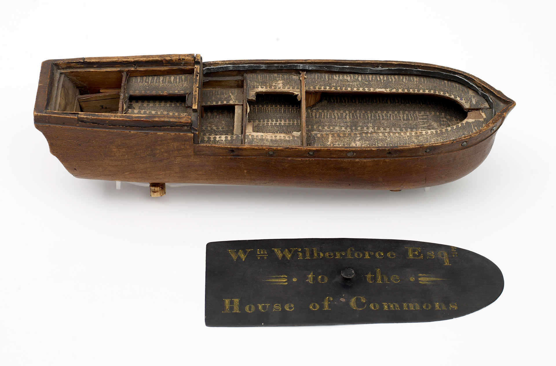 A wooden model of a slave ship.