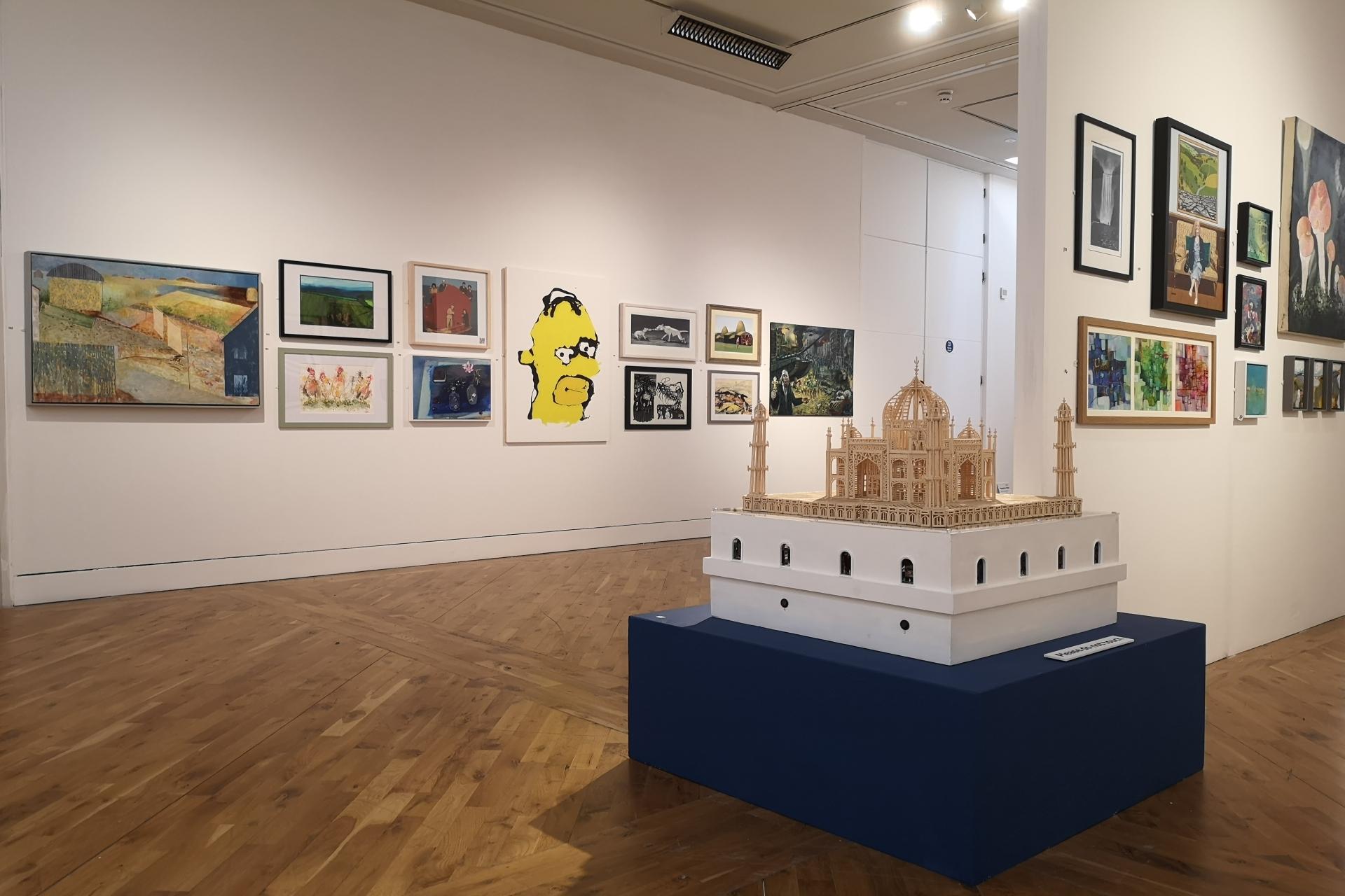 A sculpture and painting sin a gallery space