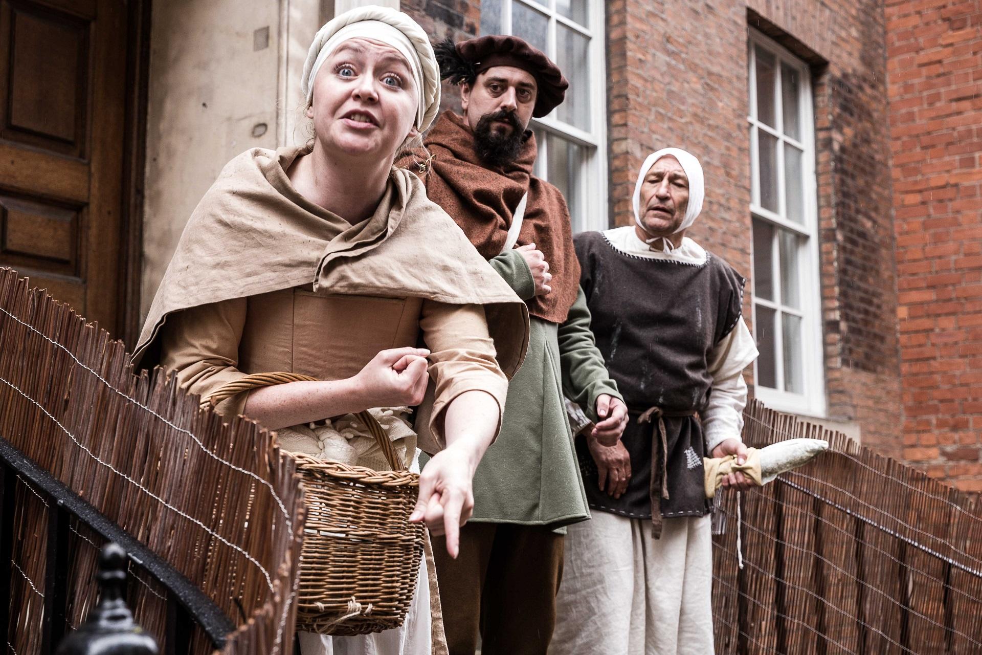 3 people dressed in medieval costume.
