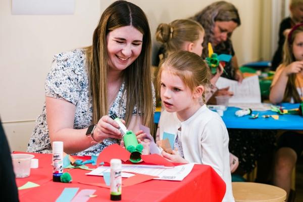 A woman and a girl taking part in a craft activity