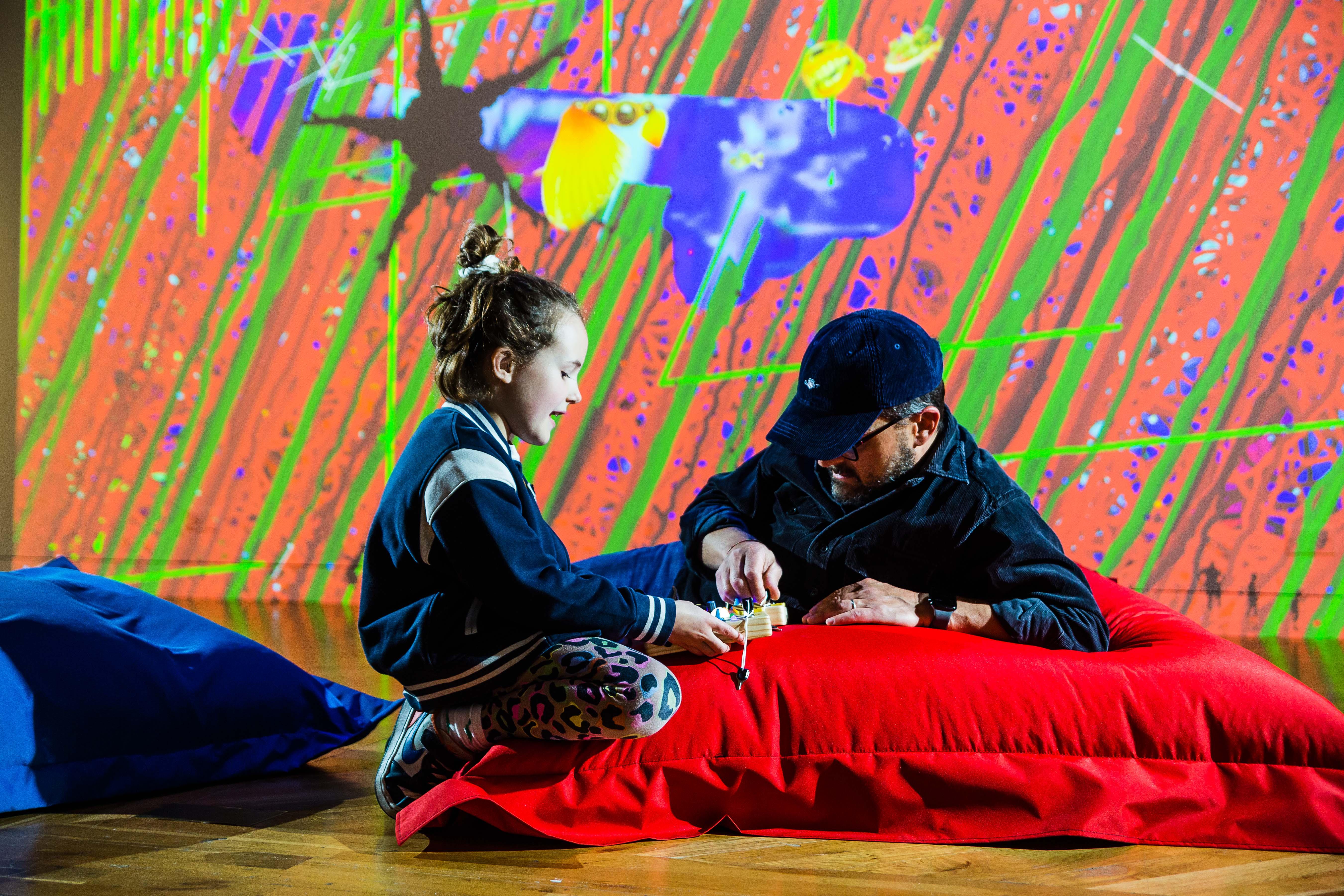 Two people laid on a red bean bag