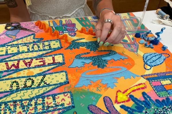 A pair of hands working with embroidery