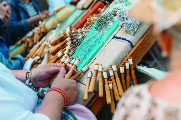 A person making lace using traditional techniques