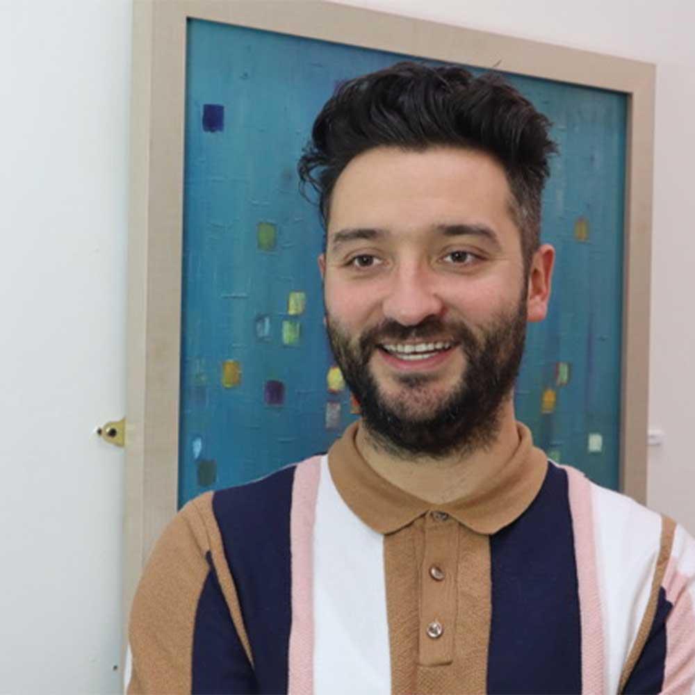 A white man with dark hair and a beard