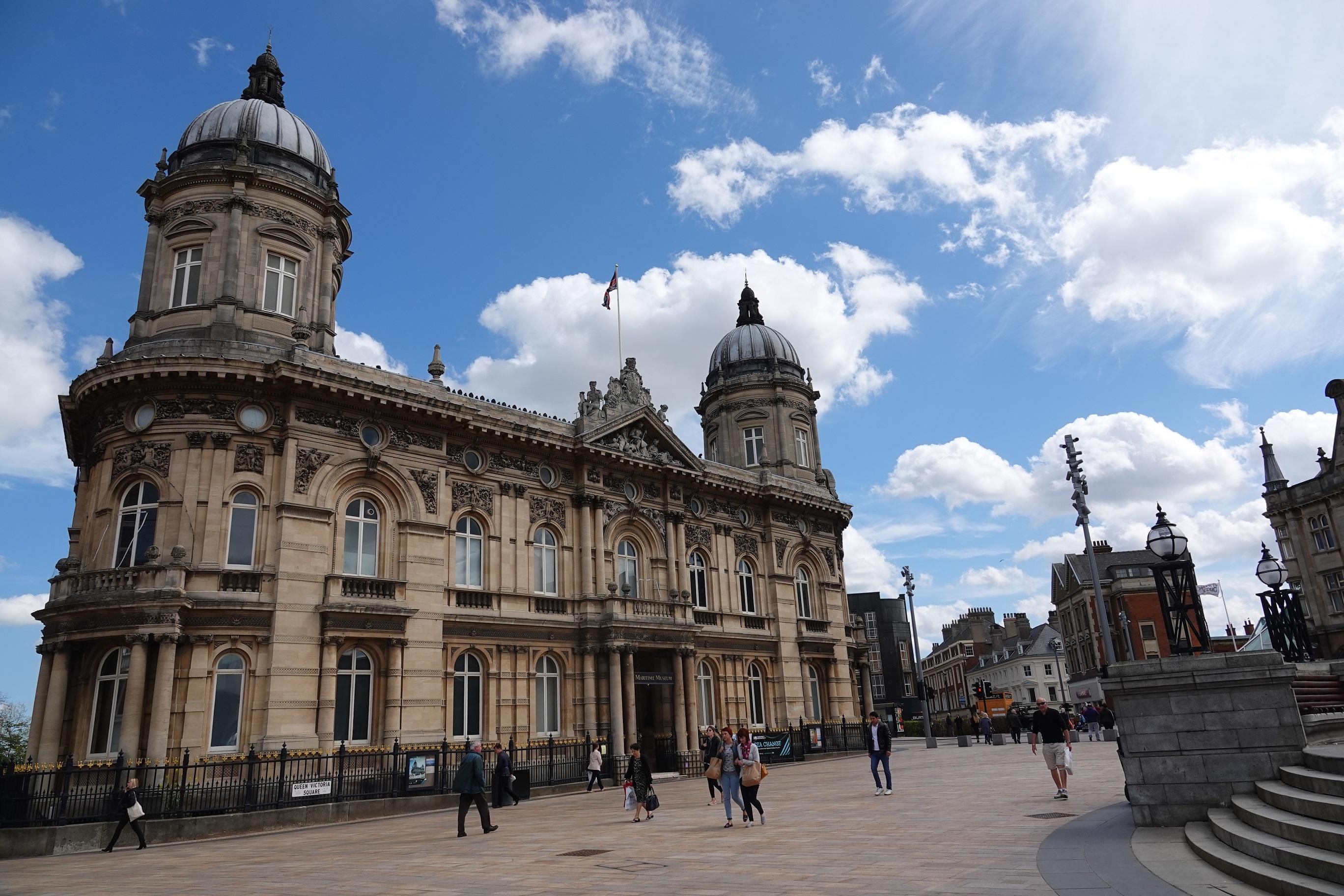 A large two storey building with two large domes on the roof