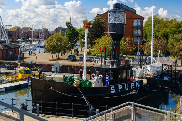 A lightship in a marina