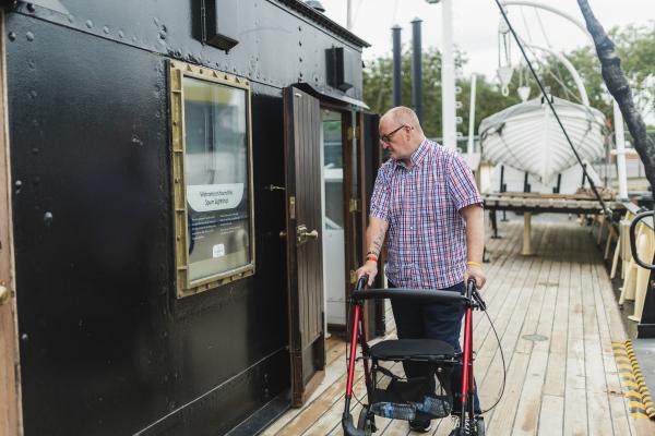 A man looking through a window on a ship.
