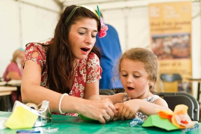 A woman and a girl taking part in a craft activity.