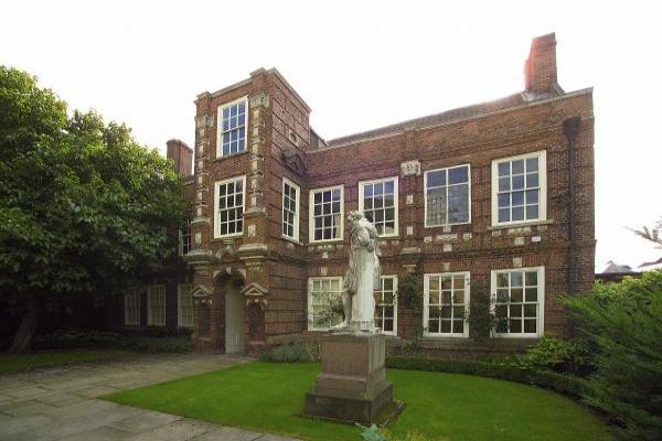 A two storey red brick building with white framed windows.