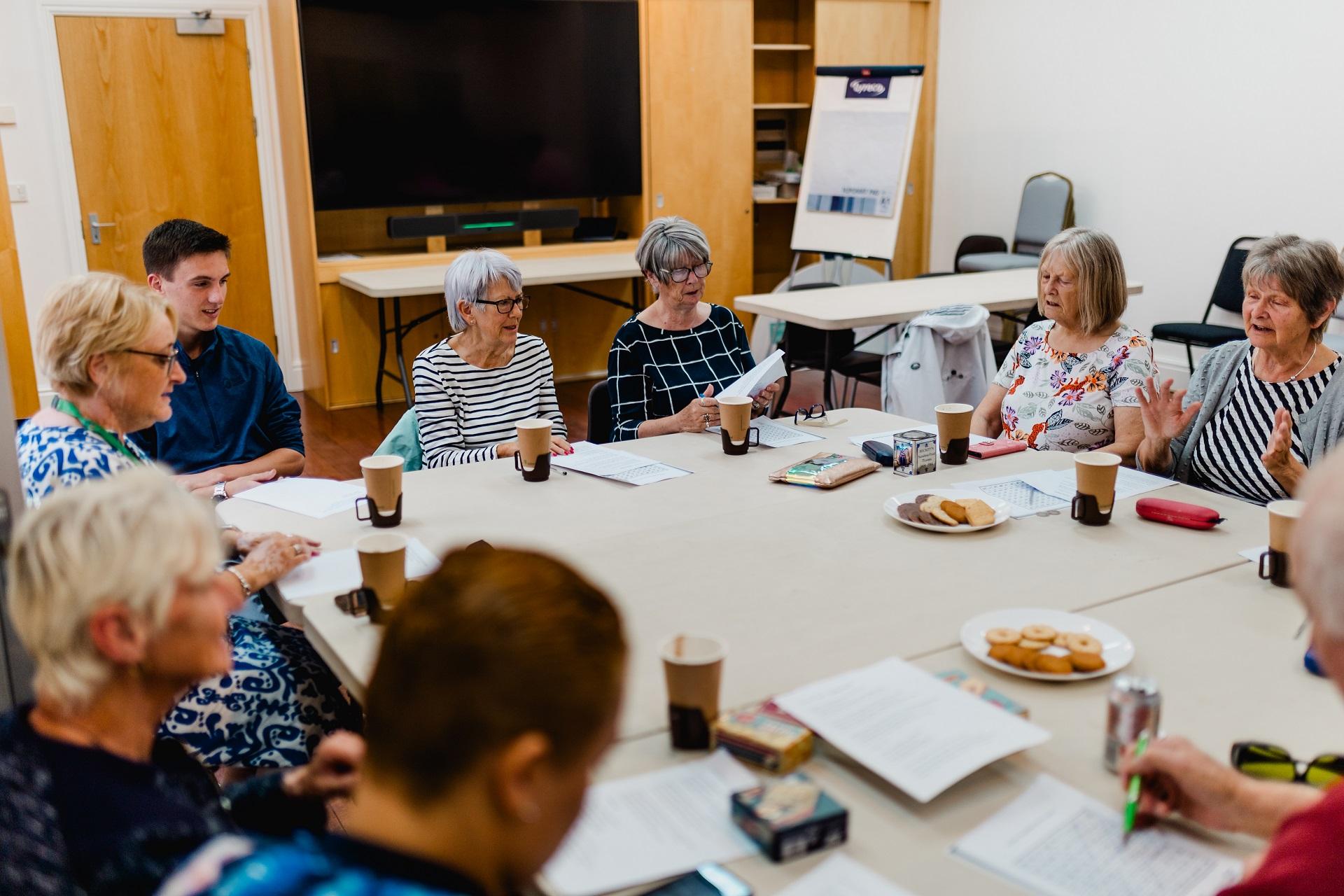 A group of people sat around tables