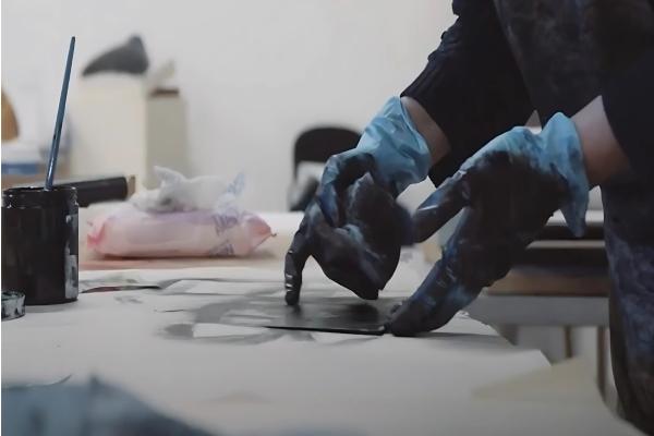 Pair of hands working with printing materials