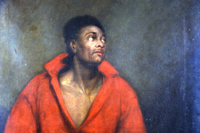 Portrait of a black woman wearing a red top.