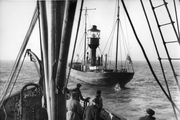 Black and white photo of a ship in a river.
