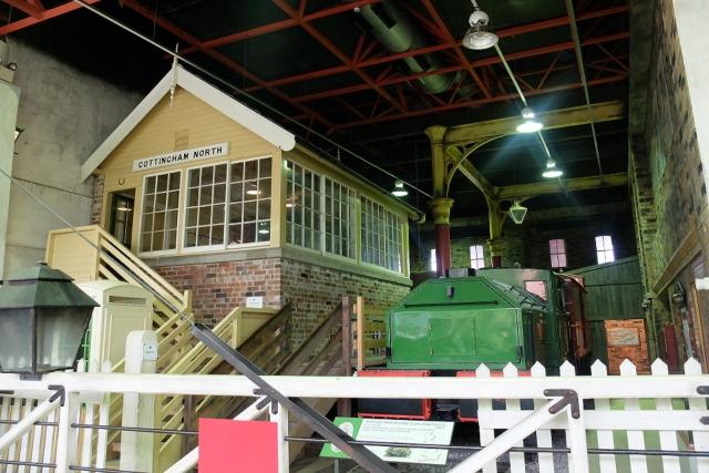 A train and signal box in a museum